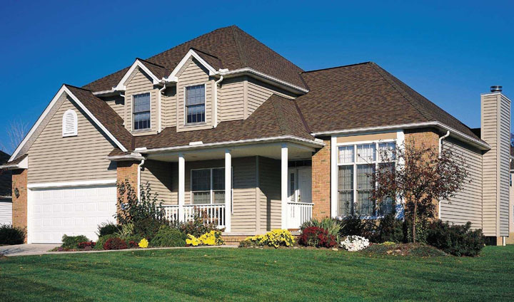 Multi level family home made with vinyl siding exterior and dark brown shingle roof